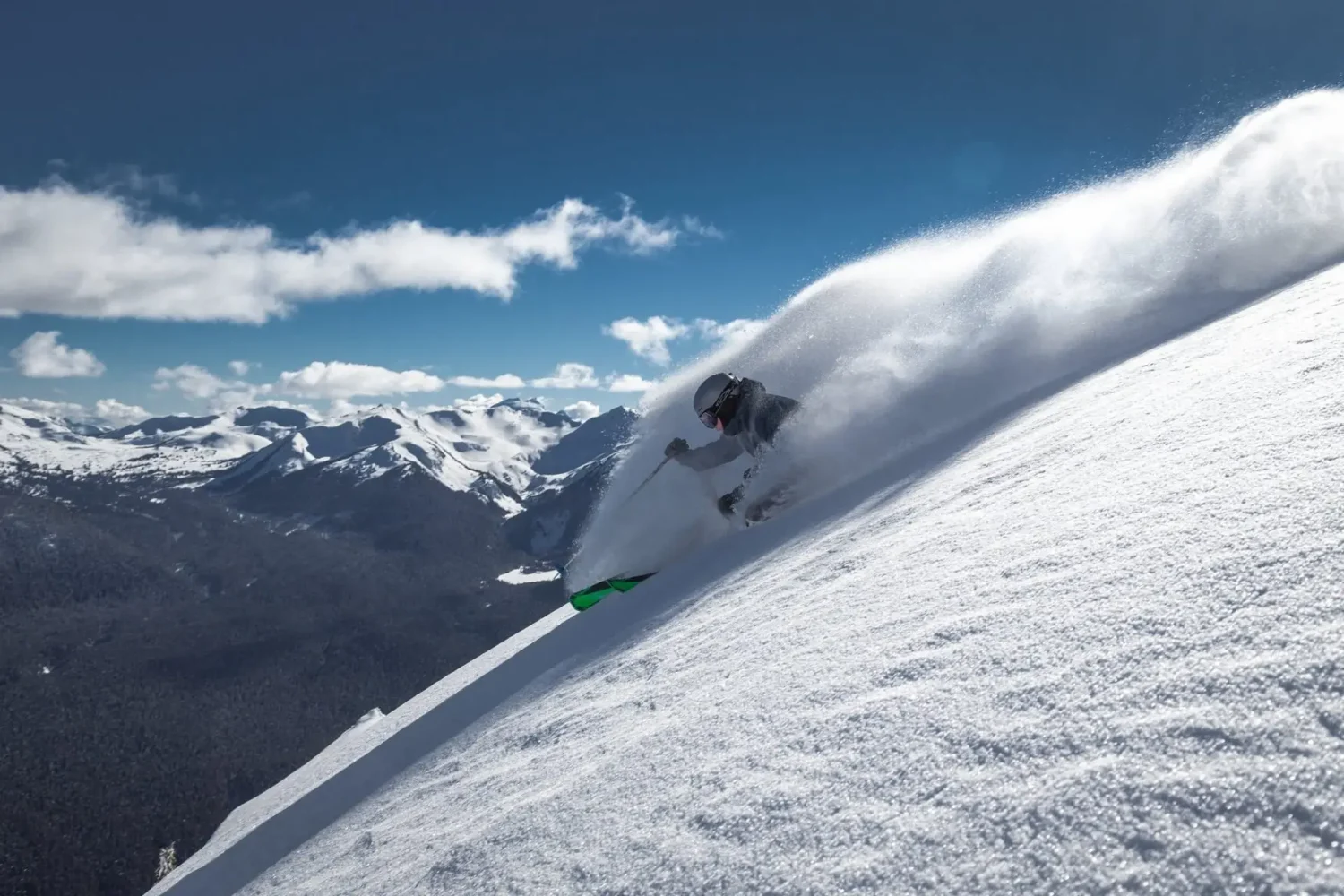 Skier in deep powder on an off piste ski course in Whistler