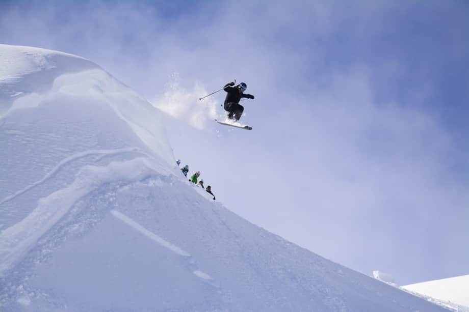 skier on cliff drop whistler